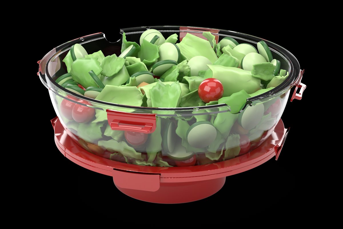 Bowl 2 of The Miracle Mixer, the clear half, filled with salad